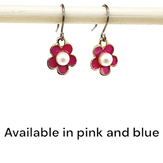 Forget-Me-Not Charm earrings in pink with a pearl in the center and a titanium hook on a white background