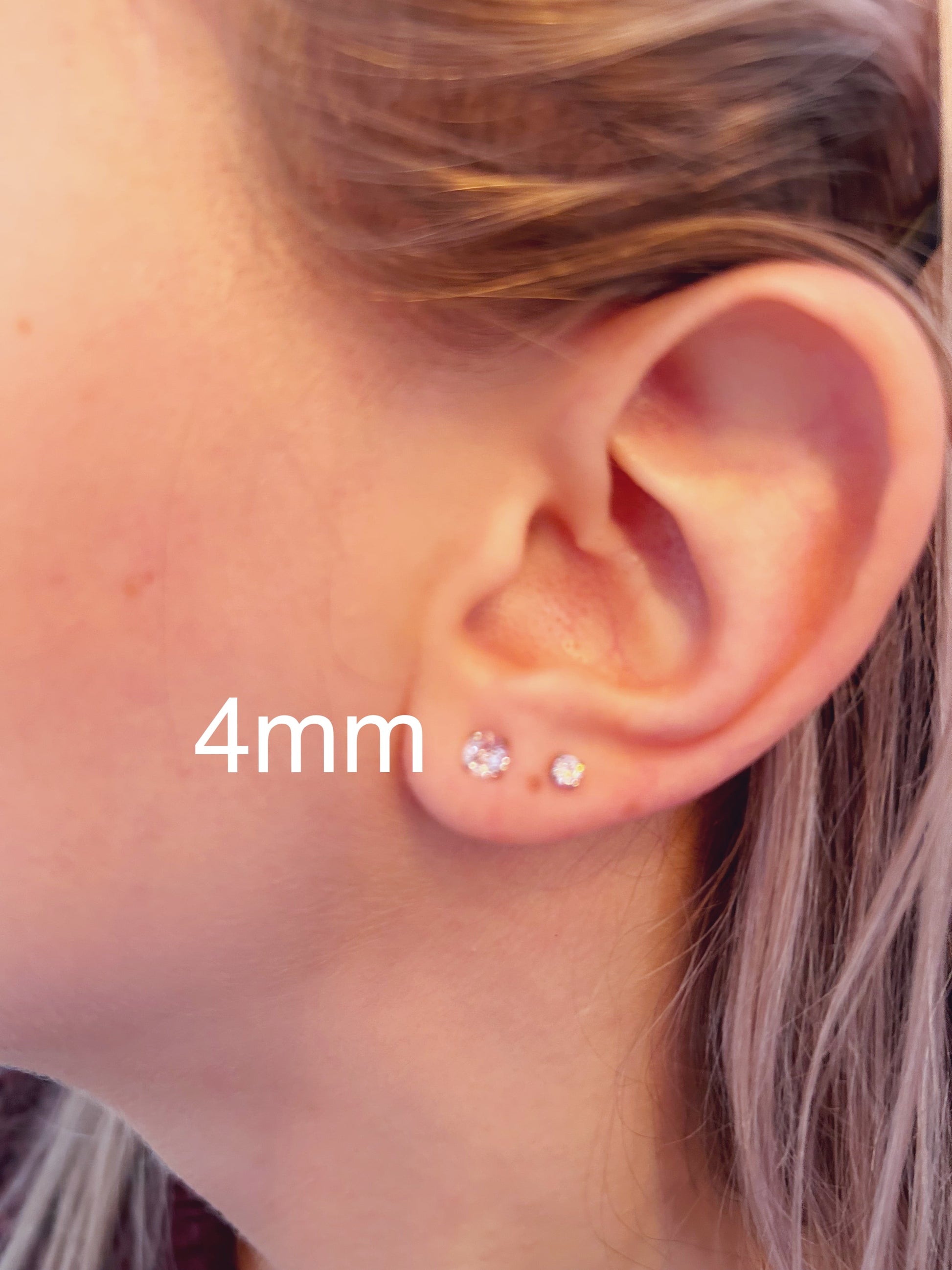 Diamond Gem Titanium Studs 4mm standard fit. On a white woman.