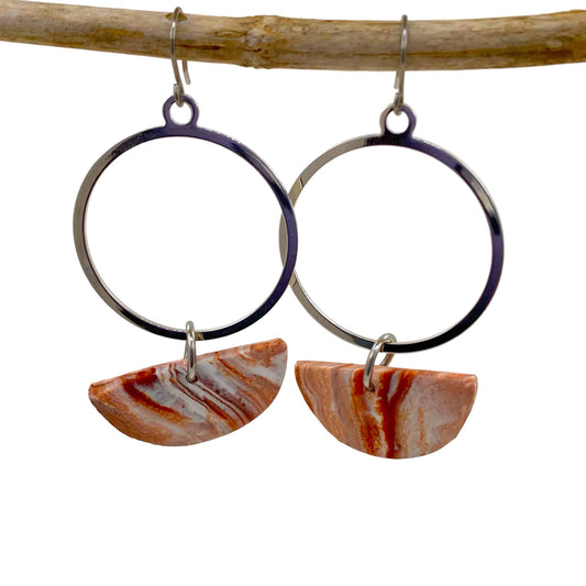 Geometric circle polymer clay earrings and a titanium hook on a white background