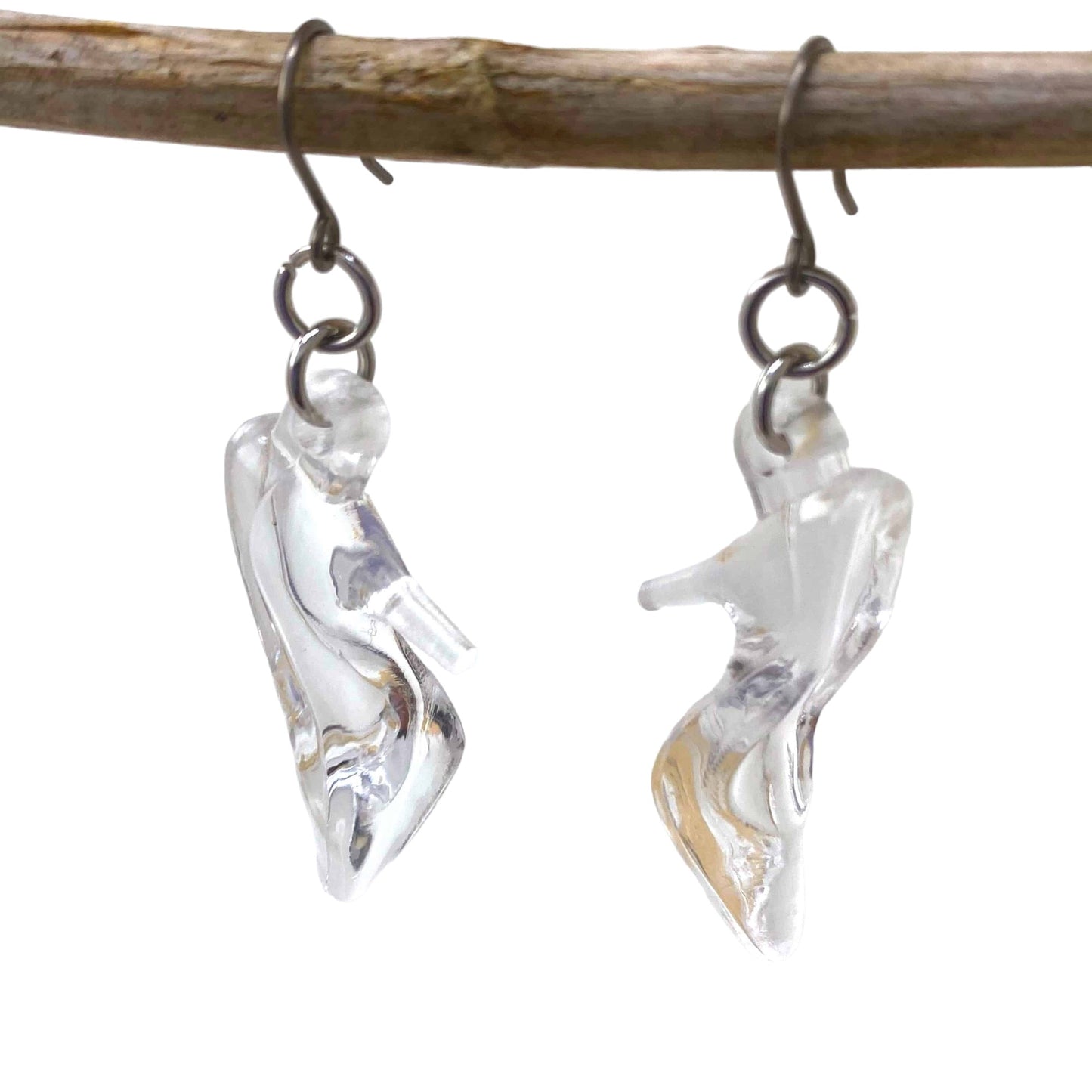 Glass Slipper Charm earrings that are clear and a titanium hook on a white background