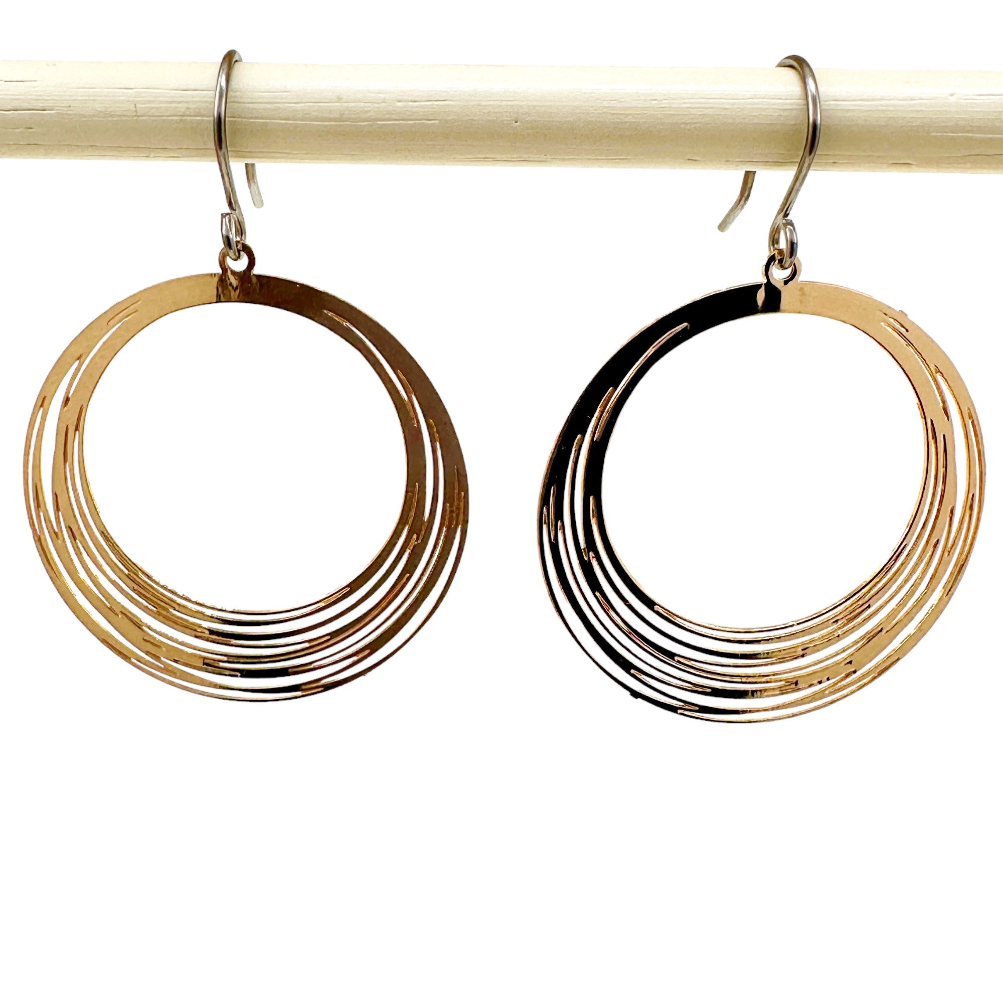 Gold String Ring earrings that are round and a titanium hook on a white background