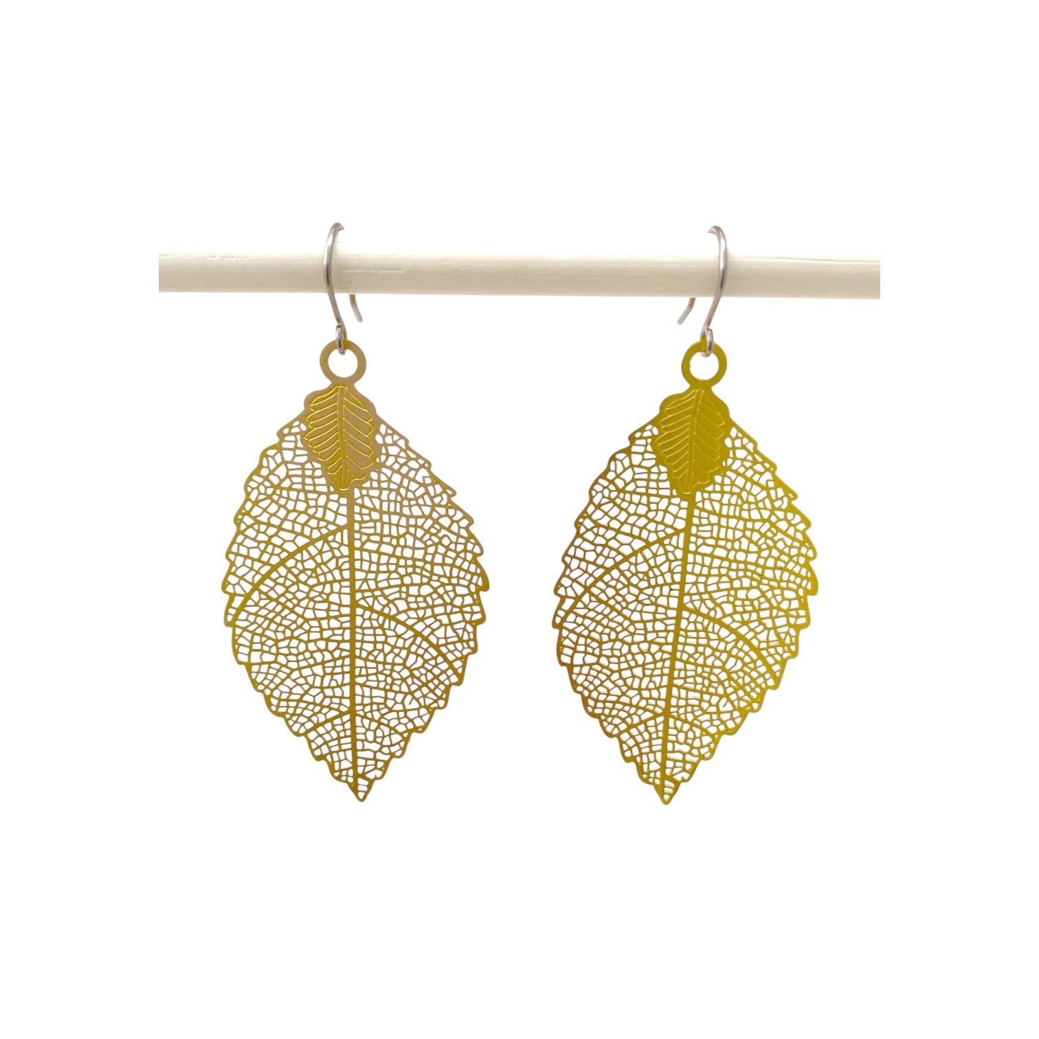 Gold leaf earring titanium on a white background