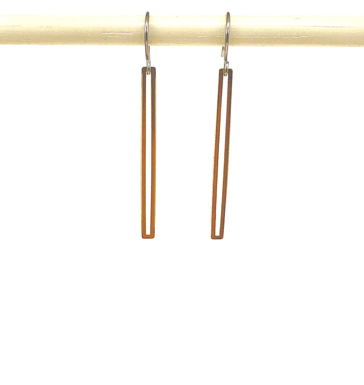 Gold narrow rectangular loop earring with a titanium hook on a white background