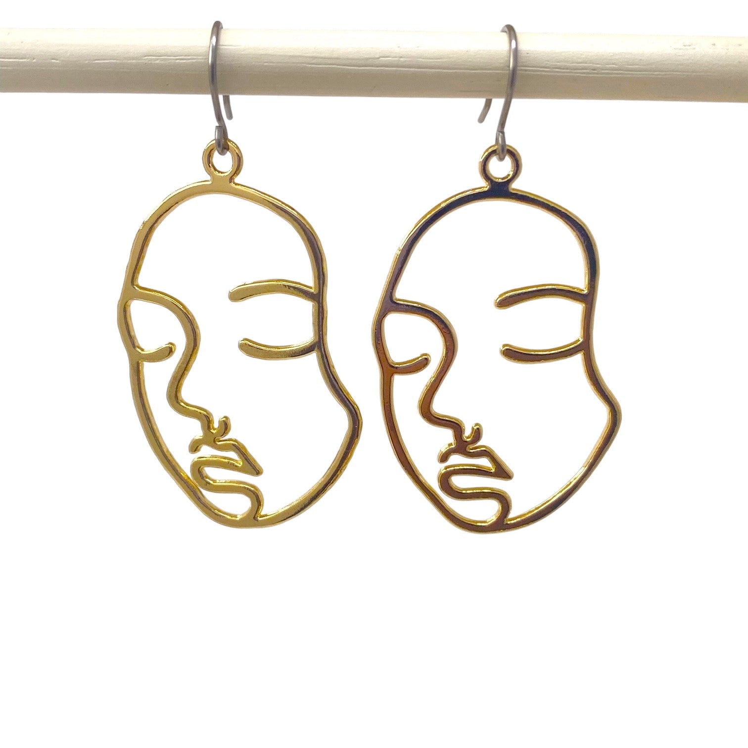 Golden face drop earrings