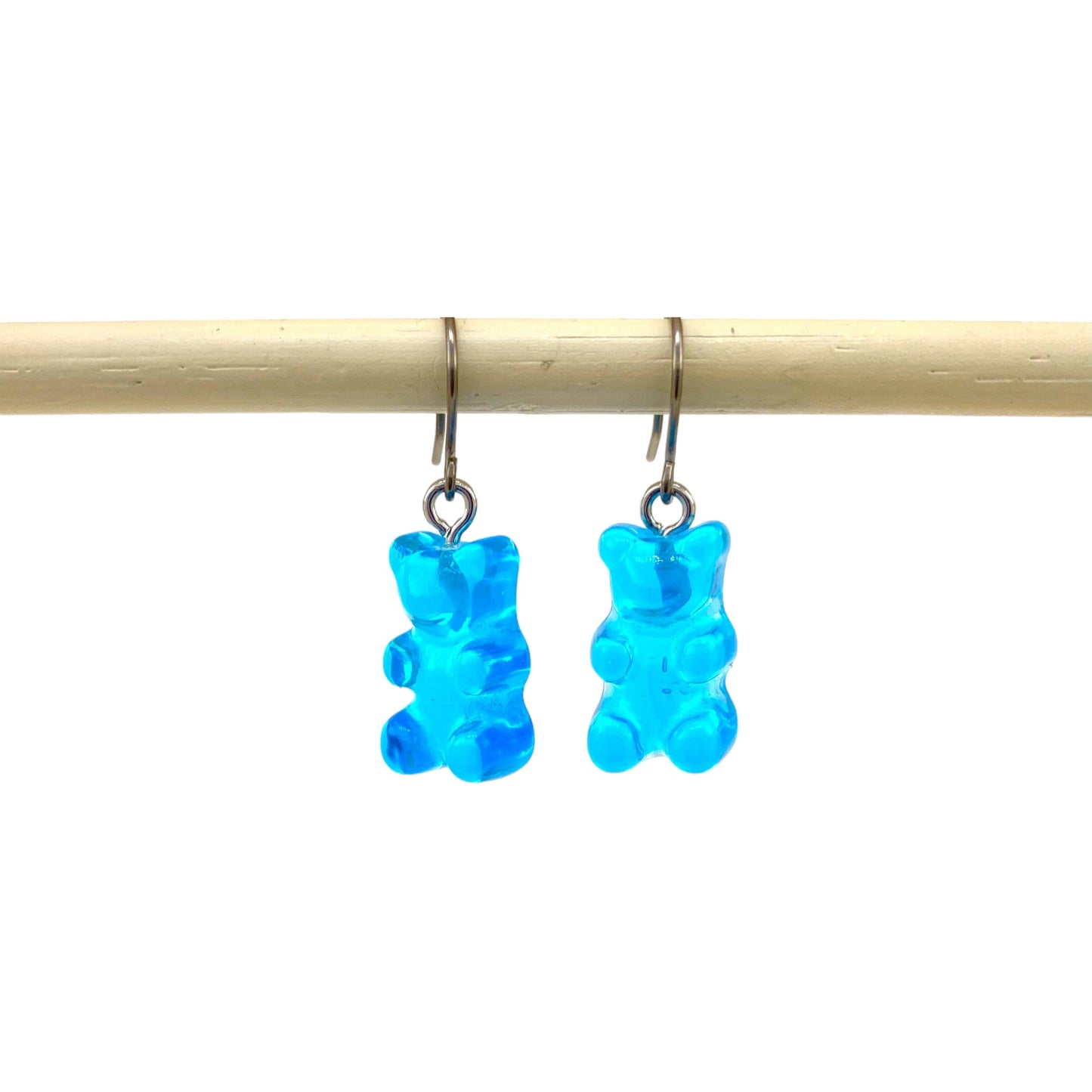 Gummy bear earrings with a titanium hook on a white background. blue