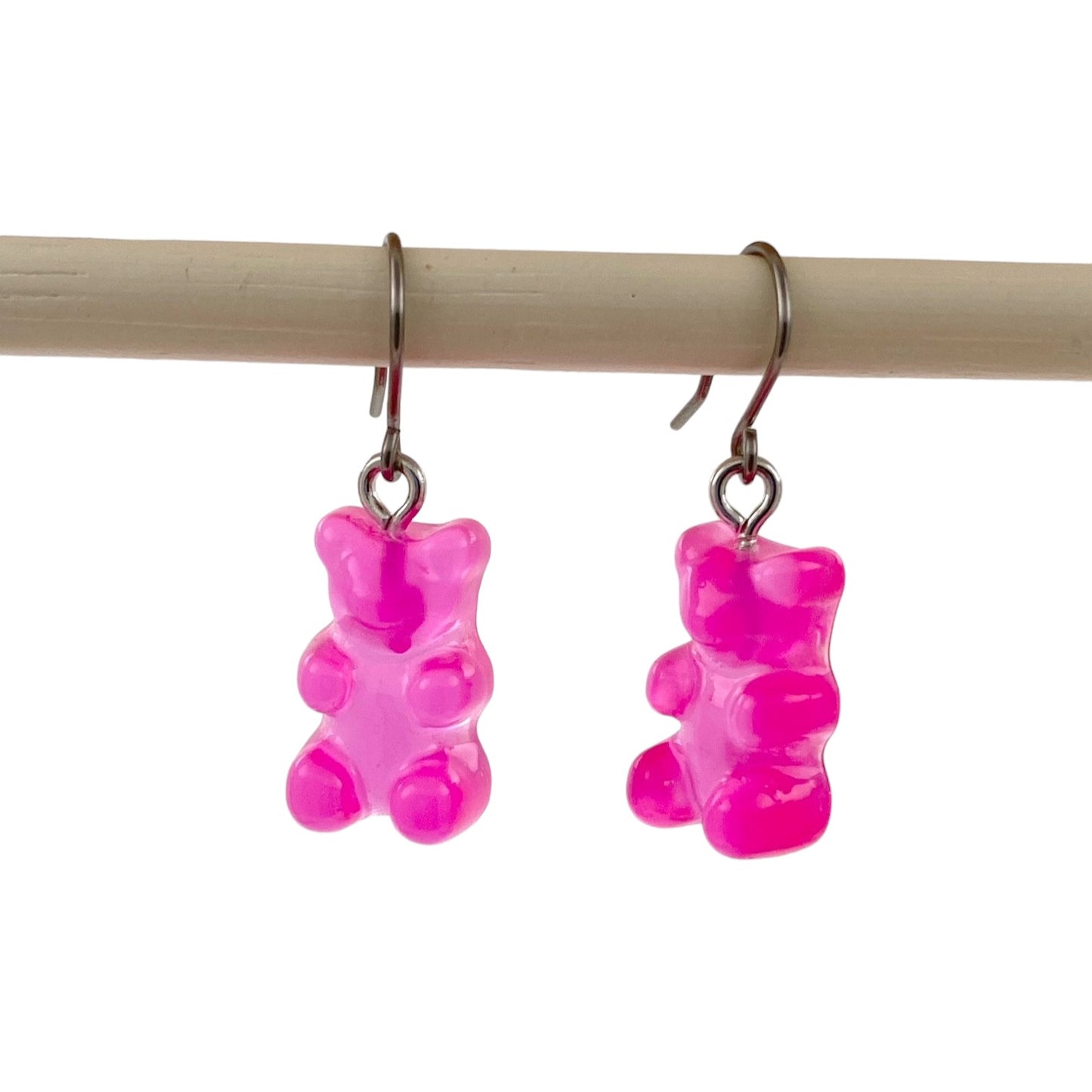 Gummy bear earrings with a titanium hook on a white background. magenta