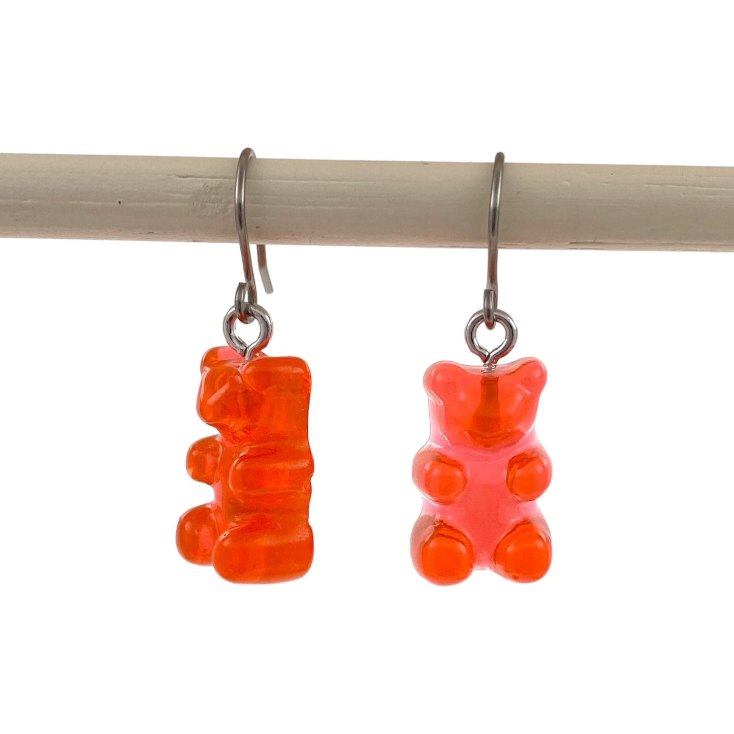 Gummy bear earrings with a titanium hook on a white background. red