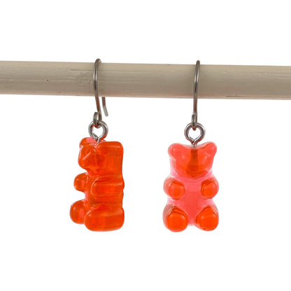 Gummy bear earrings with a titanium hook on a white background. red