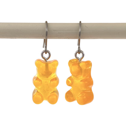 Gummy bear earrings with a titanium hook on a white background. yellow