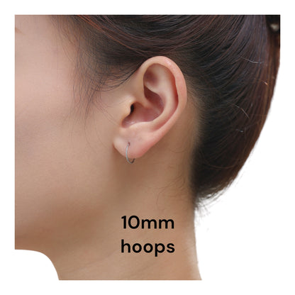 Titanium hoop Earrings 10mm on a woman  with a white background