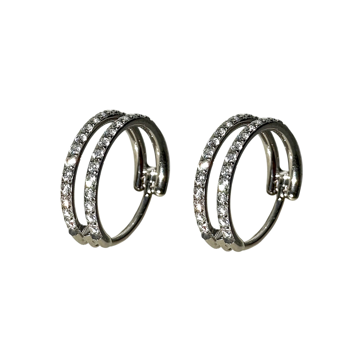 A pair of titanium double hoop earrings adorned with clear pavé-set round crystals, shown against a plain white background.