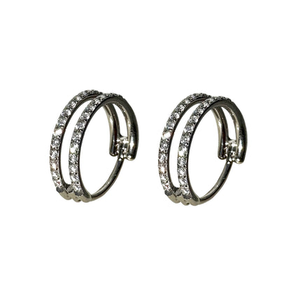 A pair of titanium double hoop earrings adorned with clear pavé-set round crystals, shown against a plain white background.