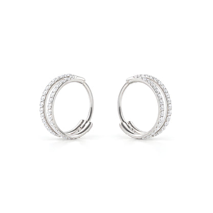 A close-up of a pair of titanium small round-shaped hoop earring with diamond gems around both hoops on a white back ground