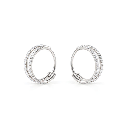 A close-up of a pair of titanium small round-shaped hoop earring with diamond gems around both hoops on a white back ground