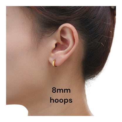 Titanium 8 mm gold hoop Earrings on a woman with a white background