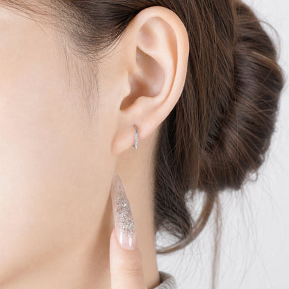 Small Hoop diamond earrings made from titanium on a white woman gem studded earring. 