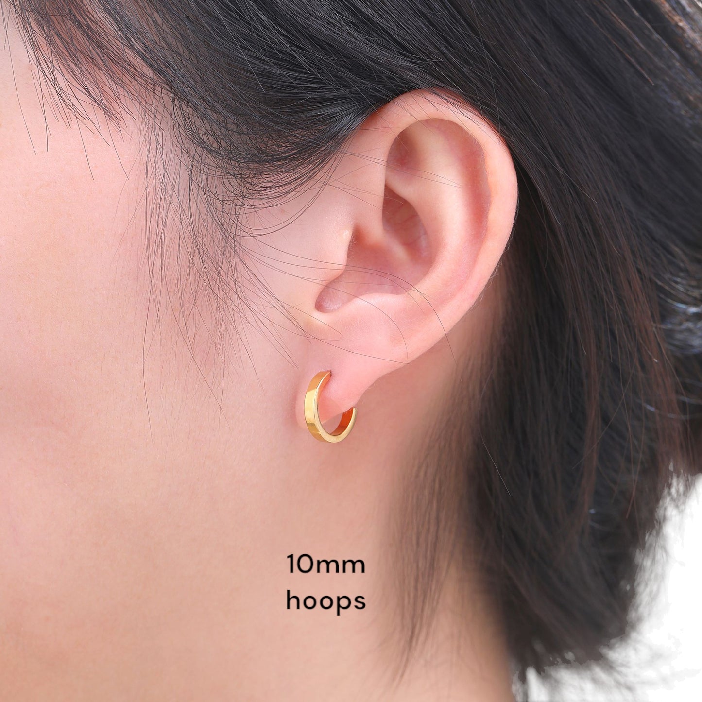 Titanium 10 mm gold hoop Earrings on a woman close up