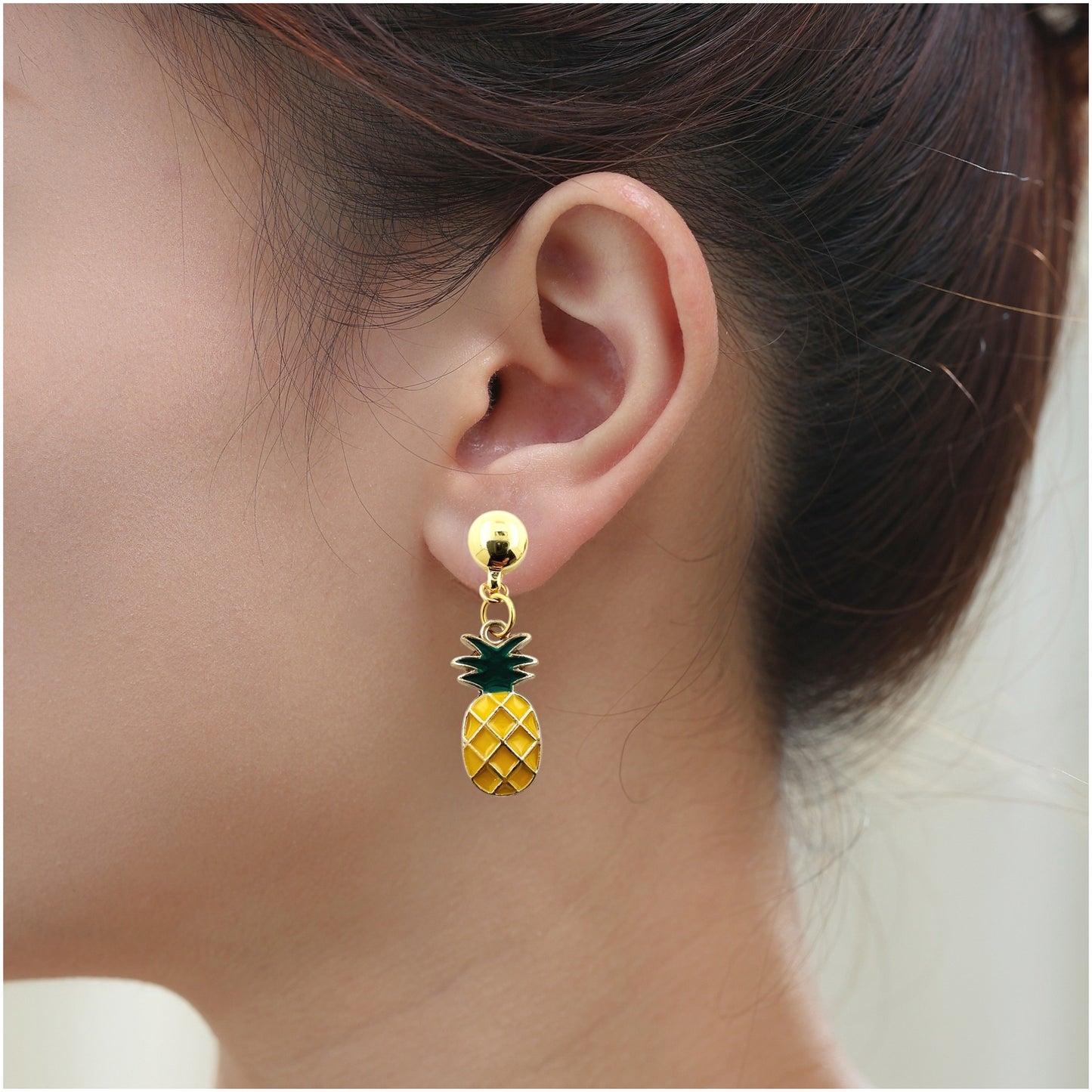 Pineapple Charm Earring. Detachable earrings truly hypoallergenic on a white young woman