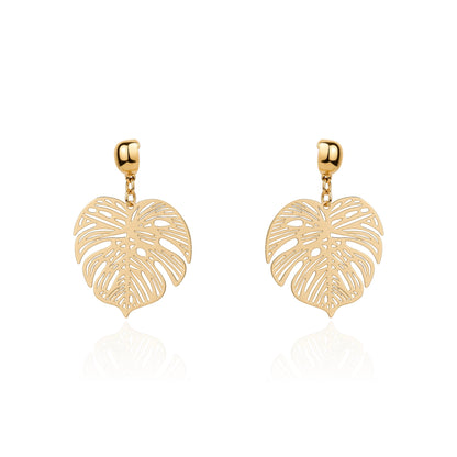 A pair of gold interchangeable drop earrings featuring openwork monstera leaf designs, displayed on a clean white background with a soft reflection below.