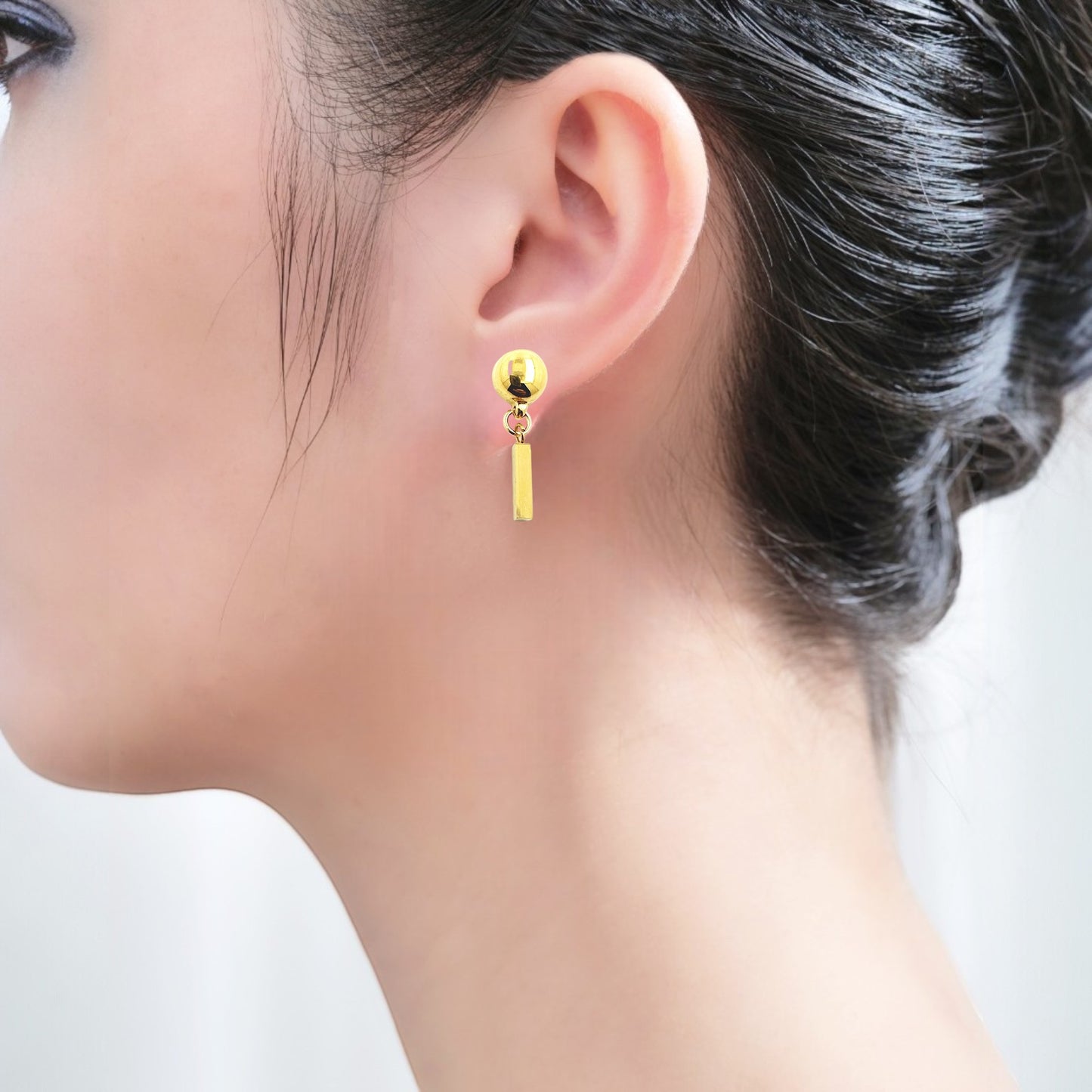 Interchangeable-magnetic-Mini-gold bar-earrings on a white woman