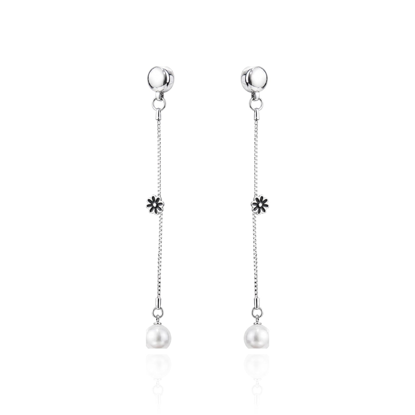 A pair of ti-go titanium interchangeable magnetic dangle earrings with a small flower charm and a white pearl drop, shown on a clean white background with a subtle reflection.