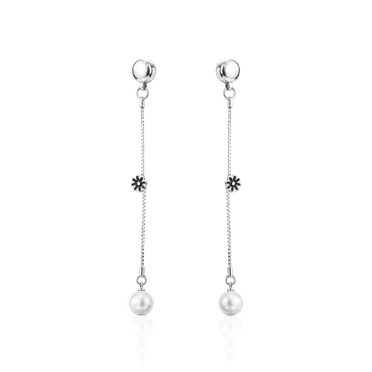 A pair of ti-go titanium interchangeable magnetic dangle earrings with a small flower charm and a white pearl drop, shown on a clean white background with a subtle reflection.