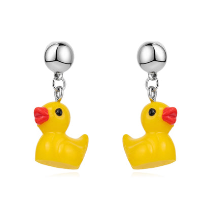 A pair of yellow rubber duck dangle magnetic interchangeable earrings with shiny silver ball studs and red beaks, shown on a clean white background.
