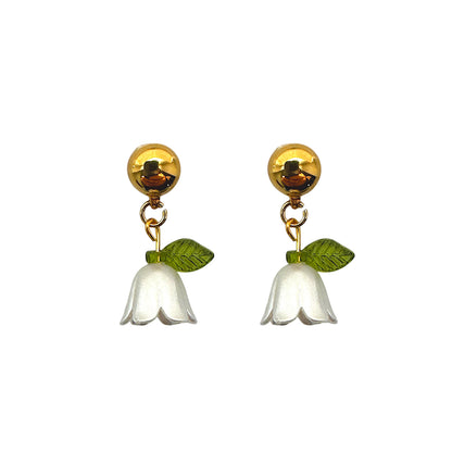 Interchangeable magnetic white blue bell flower titanium earrings pair on a white background