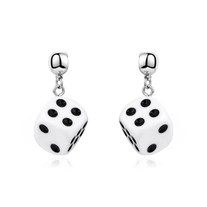 A pair of interchangeable magnetic silver dangling earrings featuring white dice charms with black printed dots, shown on a clean white background.