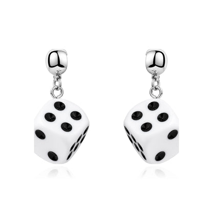 A pair of interchangeable magnetic silver dangling earrings featuring white dice charms with black printed dots, shown on a clean white background.