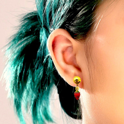 Mini strawberry red earrings with a titanium magnetic stud on a white background