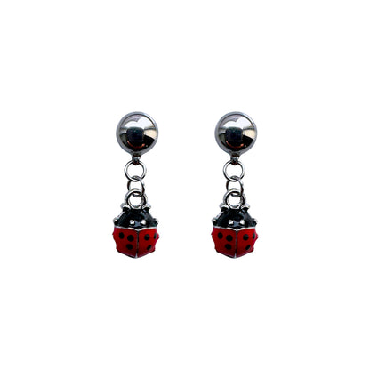 A pair of magnls interchangeable ladybug earrings with red and black color scheme, attached to silver-colored Studs