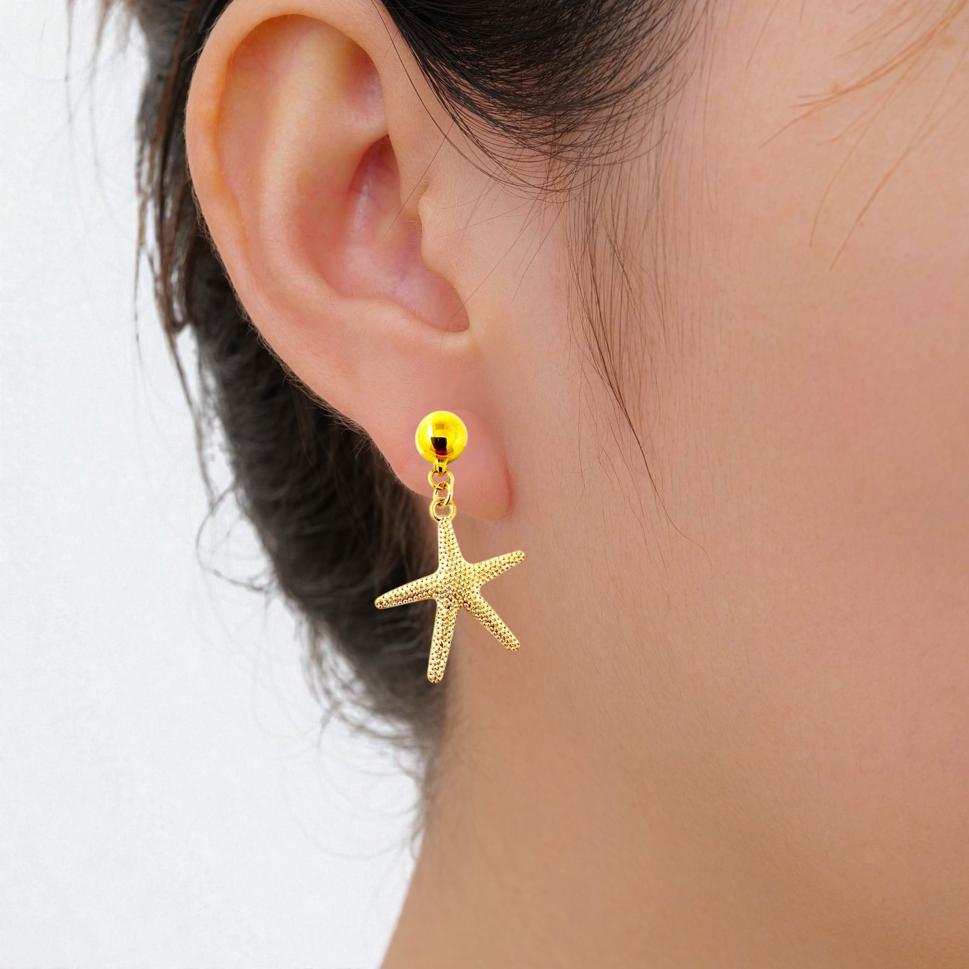 Starfish Charm earrings. Detachable earrings for a truly hypoallergenic jewellery on a white young woman