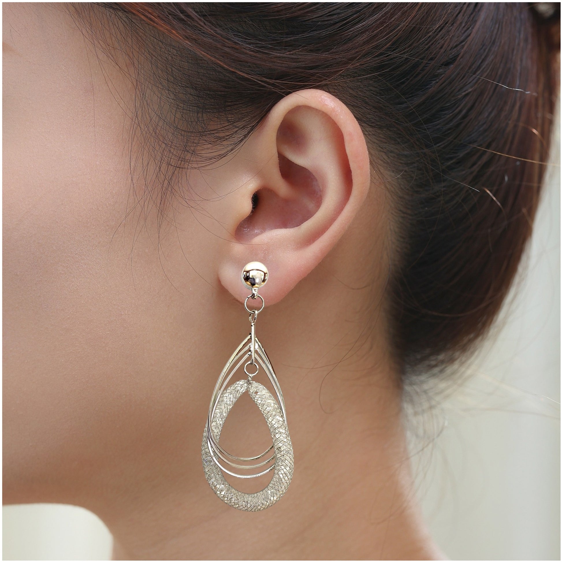 Silver Dew drop Hoops earrings. Magnetic titanium interchangeable earring system. Detachable earrings for a truly hypoallergenic jewellery on a white young woman.