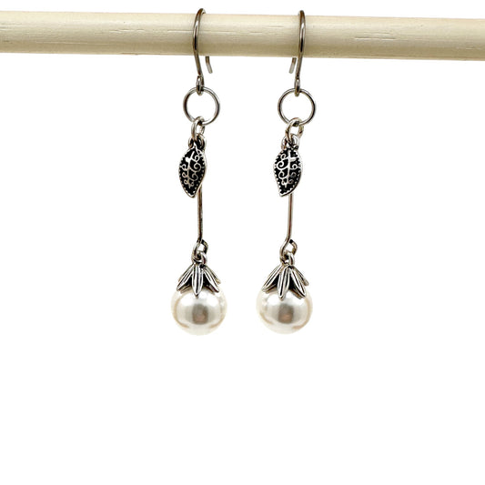 Leaf and Pearl Earrings with a titanium hook on a white background