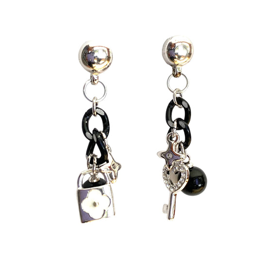 Magnetic Lock and Key Charm earrings. Detachable earrings for a truly hypoallergenic jewellery on a white background