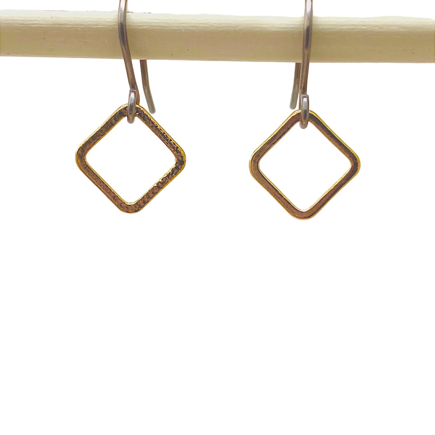 Looped square minimal earrings with a titanium hook on a white background