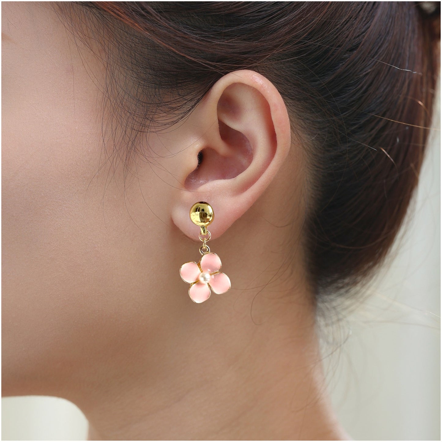 Forget-Me-Not Earrings. Magnetic titanium interchangeable earring system. Detachable earrings for a truly hypoallergenic jewellery on a white young woman. pink