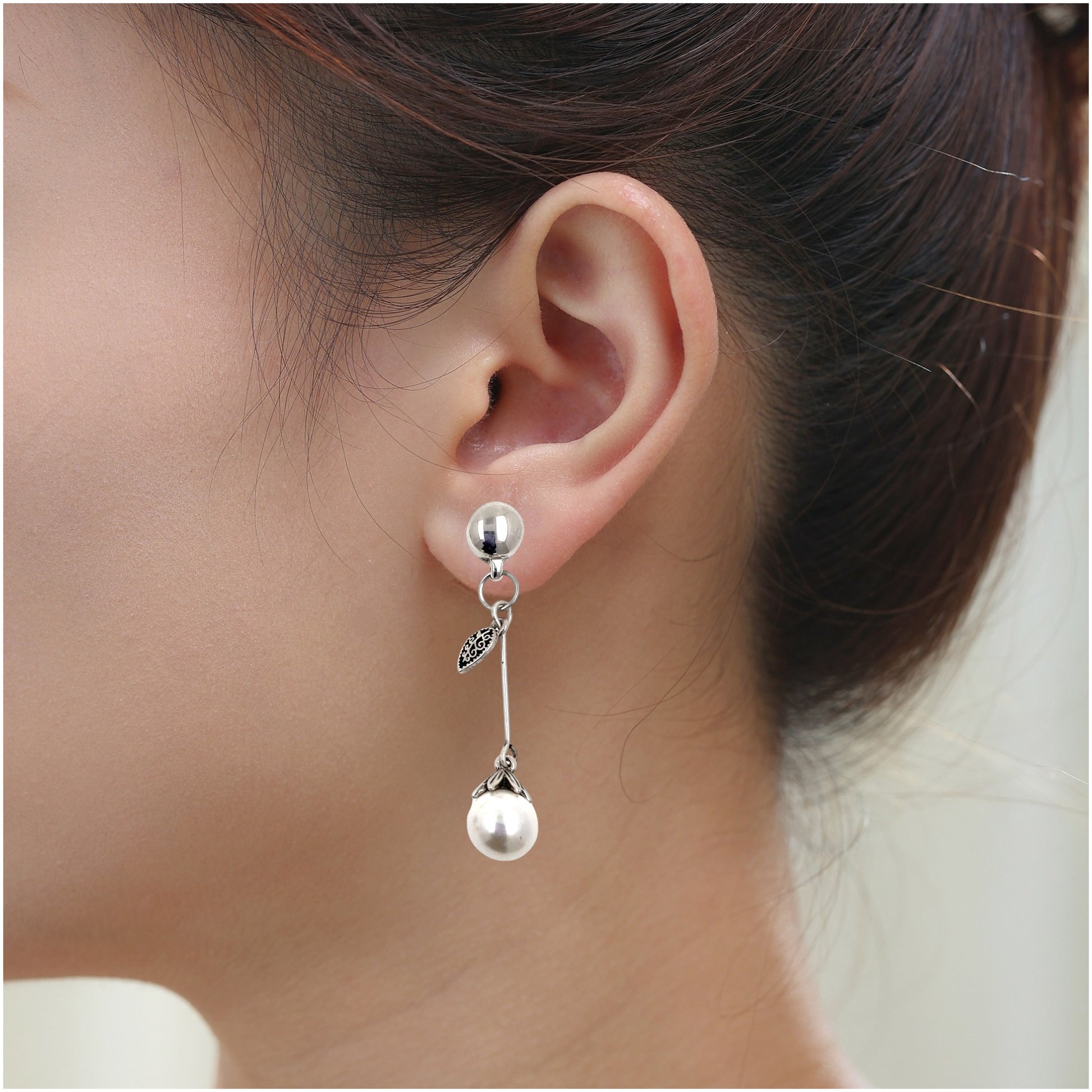 Leaf and Pearl Charm earrings. Detachable earrings for a truly hypoallergenic jewellery on a white young woman