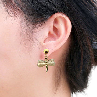 Pearly Dragonfly earrings. Detachable earrings for a truly hypoallergenic jewellery on a white young woman. white