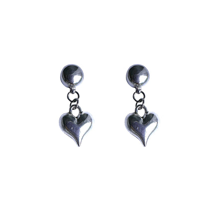 Magnetic silver heart earrings. Detachable earrings for a truly hypoallergenic jewellery on a white background