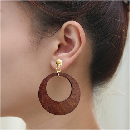 Hanging wooden hoop. Detachable earrings for a truly hypoallergenic jewellery on a white young woman