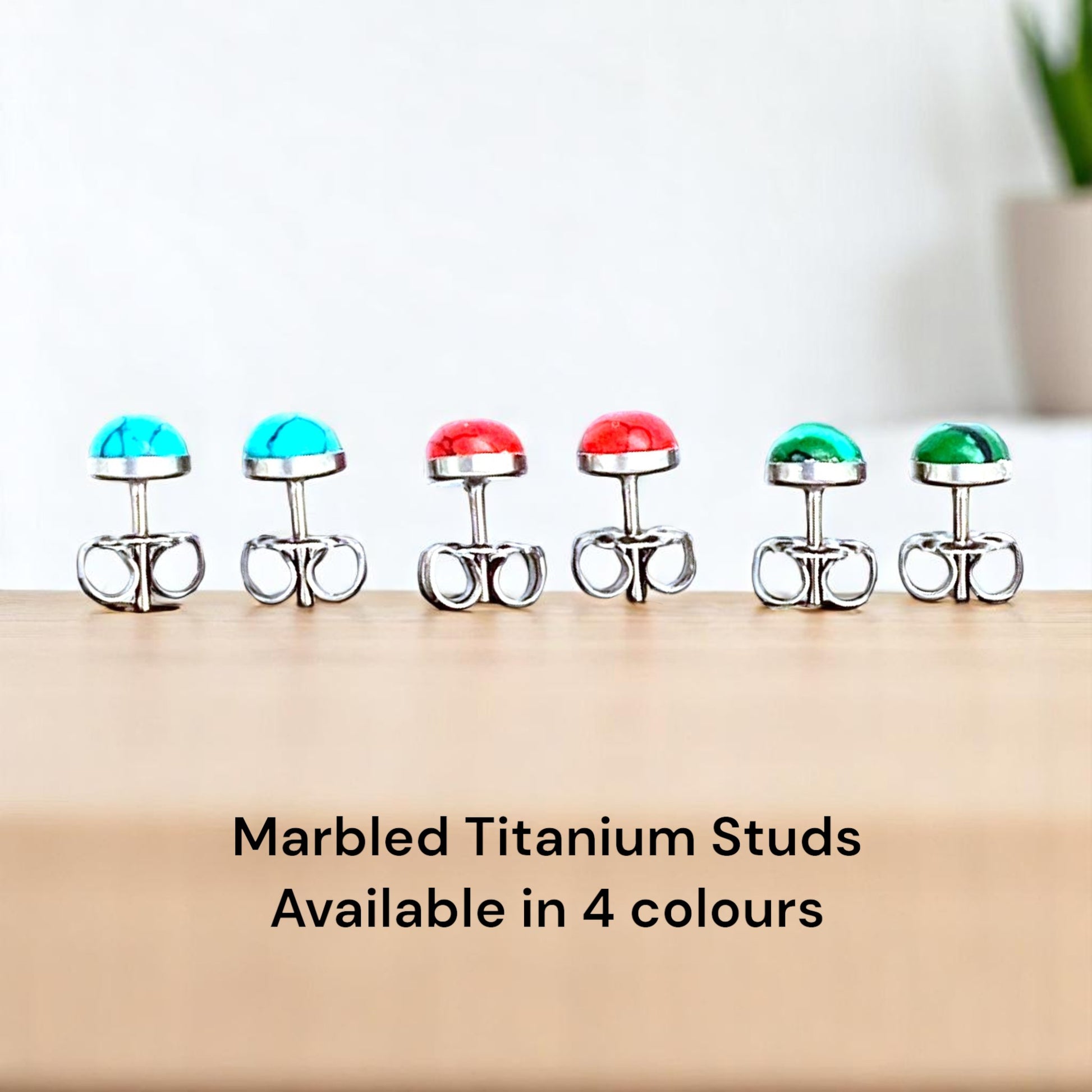 Marbled Studs solid titanium Feature a small and minimal design on a countertop background