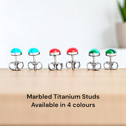 Marbled Studs solid titanium Feature a small and minimal design on a countertop background