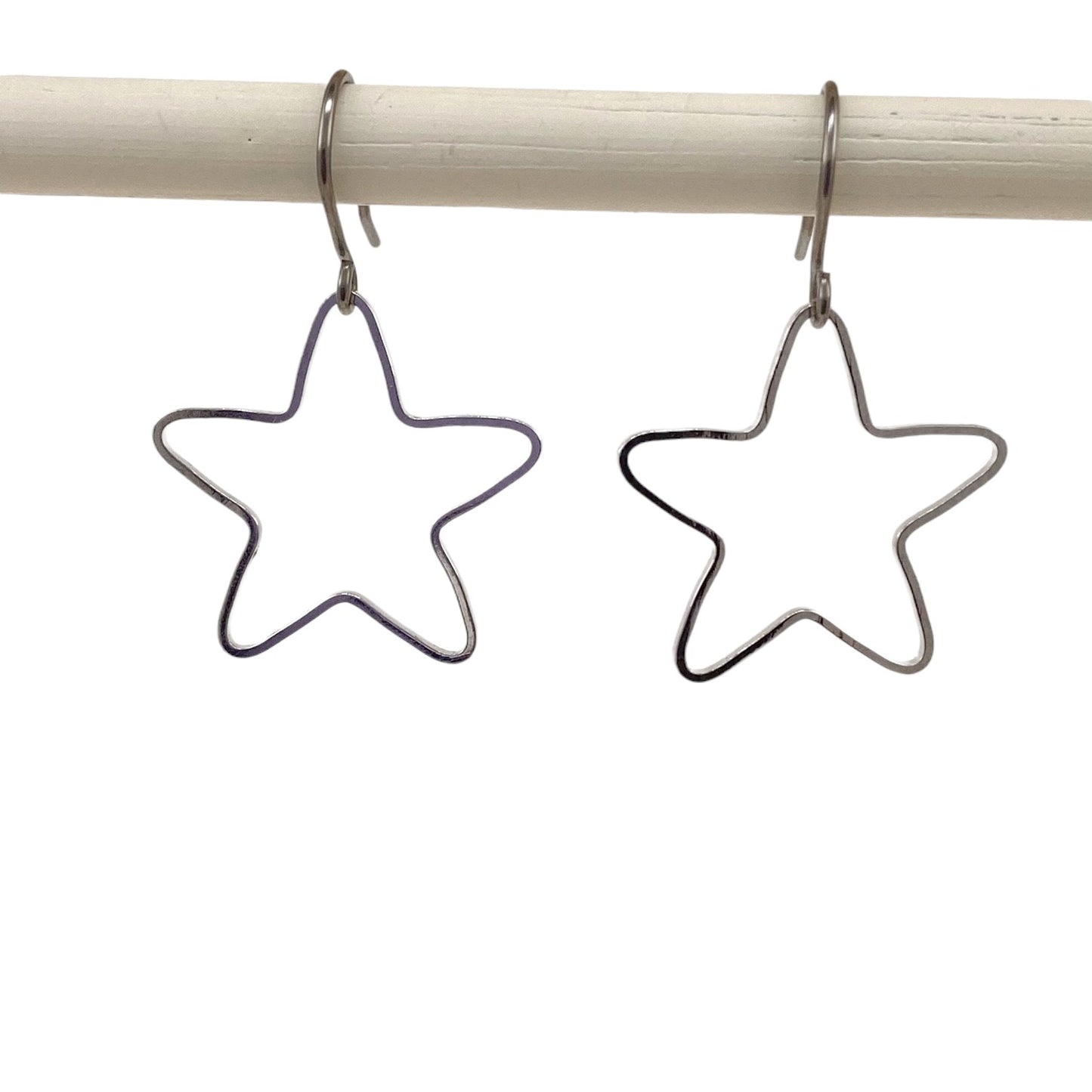 Minimal Silver Star Titanium Earrings with a titanium hook on a white background