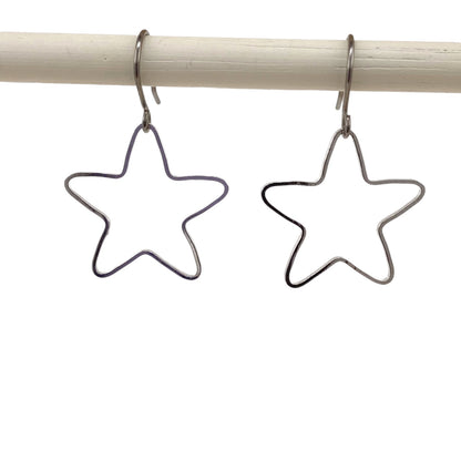 Minimal Silver Star Titanium Earrings with a titanium hook on a white background