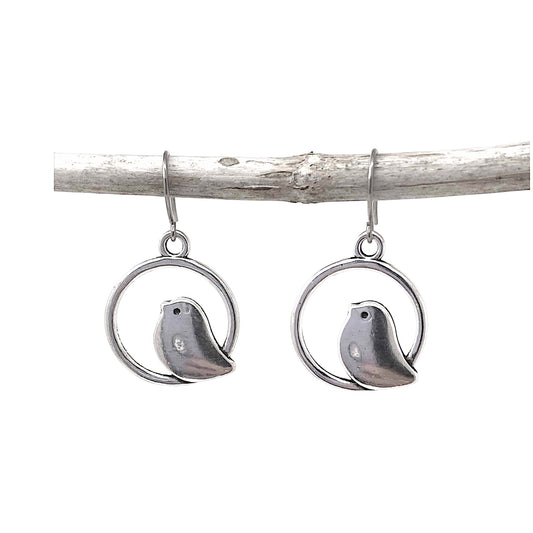 Nightingale Charm earrings with a titanium hook on a white background