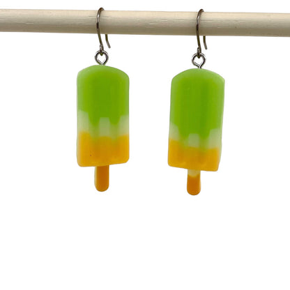 Popsicle earrings with a titanium hook on a white background. green yellow