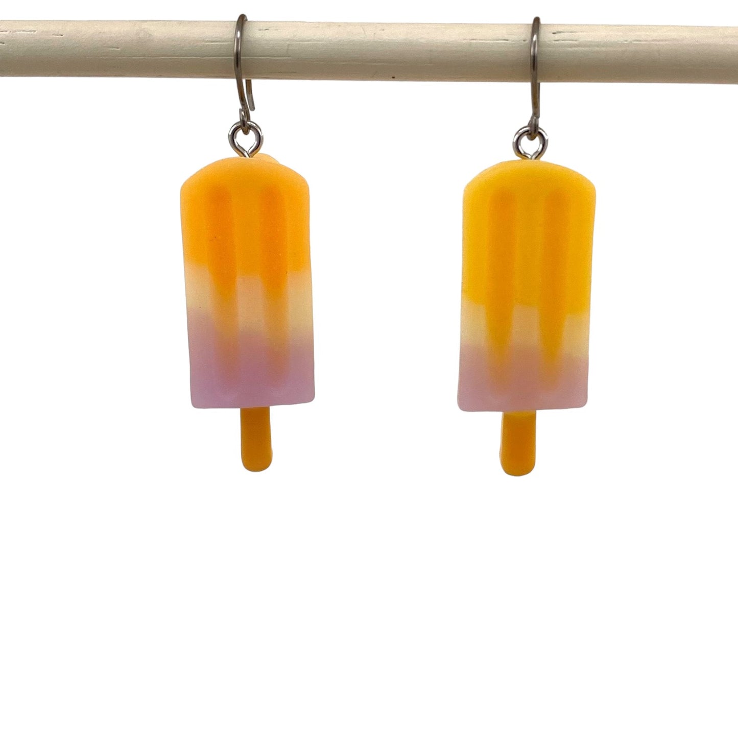 Titanium earrings with a titanium hook on a white background.  yellow purple