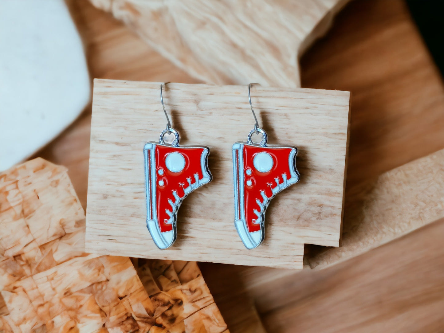 Running Shoe Charm Drop Earrings with a titanium hook on a white background . red